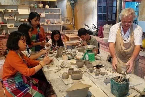 French craftsman teaches disabled children in pottery making