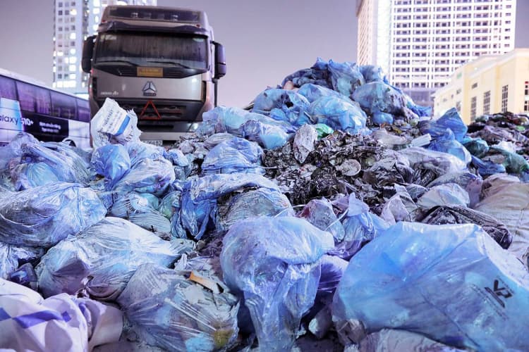 Workers rush to collect waste in Hanoi after third landfill protest ends
