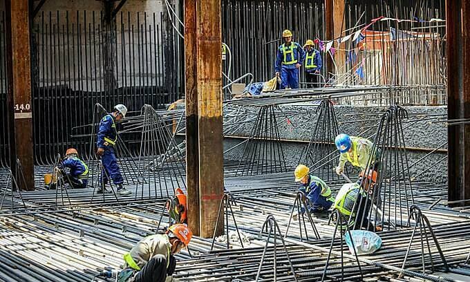 Construction giant sees profits halved