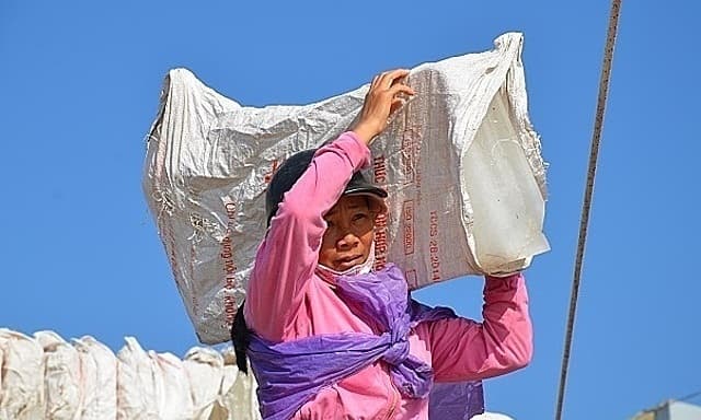 Lugging ice blocks the main source of income in 'village of widows’