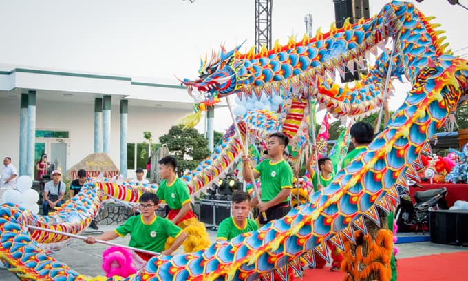 Saigon lion dancers mask longings while cheering others